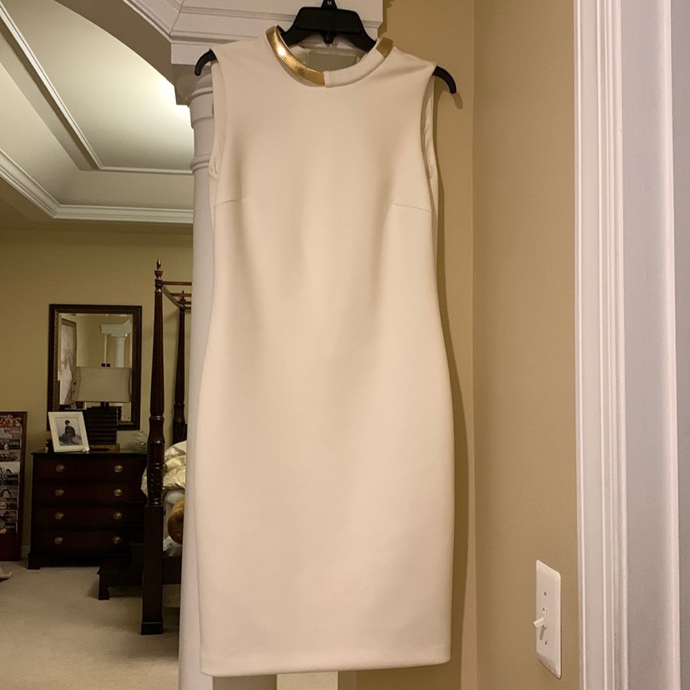 Calvin Klein white dress with build on necklace .
